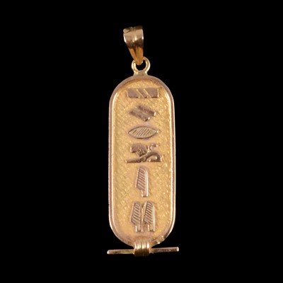 Lot 336 - A yellow metal pendant in the form of an Ancient Egyptian cartouche.