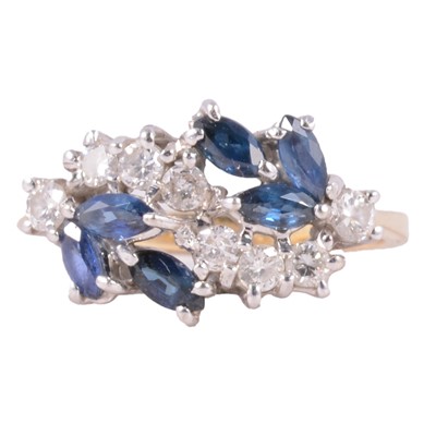 Lot 26 - A sapphire and diamond cluster ring.