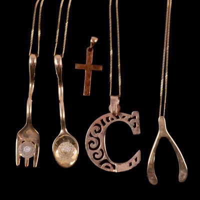 Lot 317 - Five 9 carat gold novelty pendants and four gold chains.