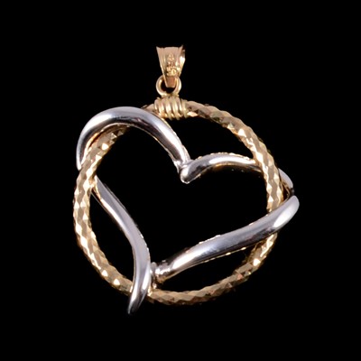 Lot 330 - An 18 carat yellow and white gold heart and circle pendant.