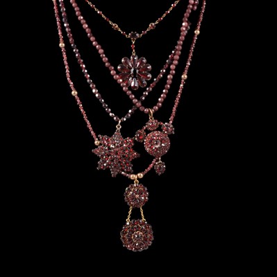 Lot 389 - Four garnet bead necklaces with pendants.