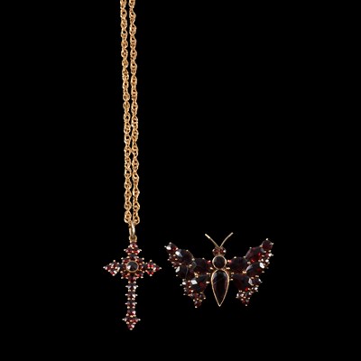 Lot 308 - A garnet set cross pendant on a chain, and a 9 carat gold garnet set butterfly brooch.