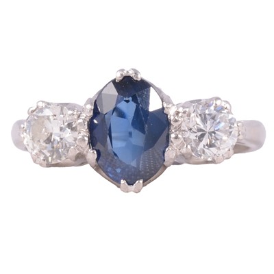 Lot 16 - A sapphire and diamond three stone ring.