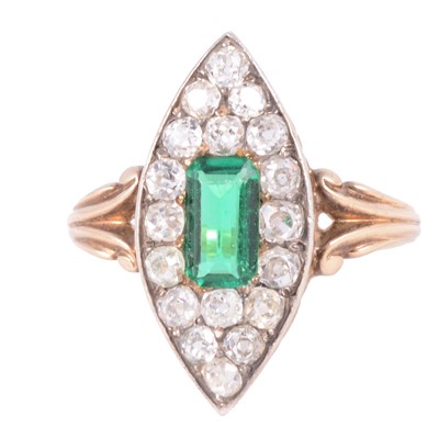 Lot 3 - An emerald and diamond marquise cluster ring.