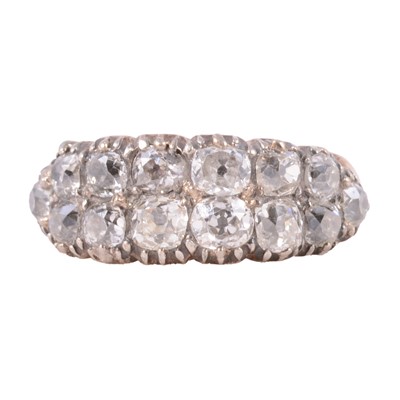 Lot 110 - A diamond two row half hoop ring.