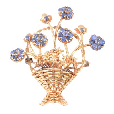 Lot 182 - A floral basket brooch set with sapphires.