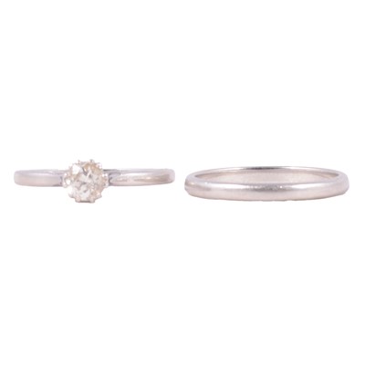 Lot 81 - A diamond solitaire ring and a wedding band.