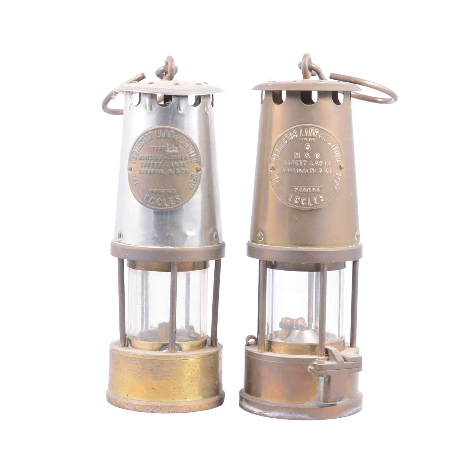 Lot 103 - Two antique miner's lamps, and two mining related figures