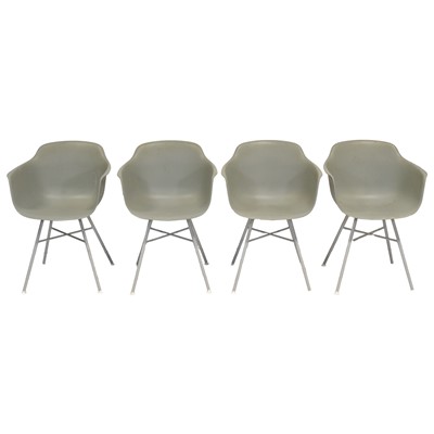 Lot 395 - Four modern plastic tub chairs, after a design by Eames