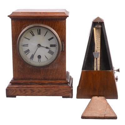 Lot 70 - Edwardian oak mantle clock and a walnut cased metronome