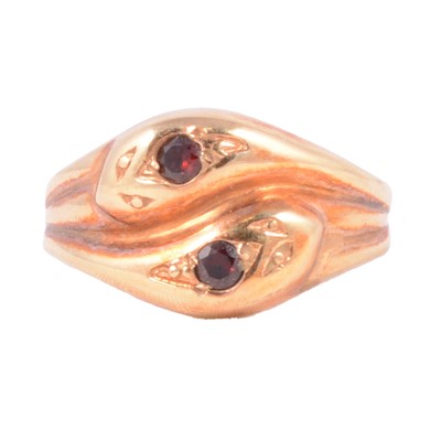 Lot 140 - A 9 carat rose gold double snake head ring.