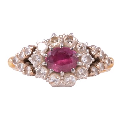 Lot 13 - A ruby and diamond cluster ring.