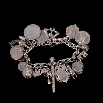 Lot 419 - A silver charm bracelet with Edwardian and later charms.