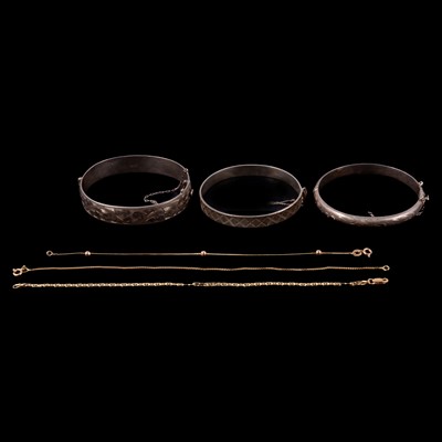 Lot 422 - Three gold bracelets, and three silver bangles.