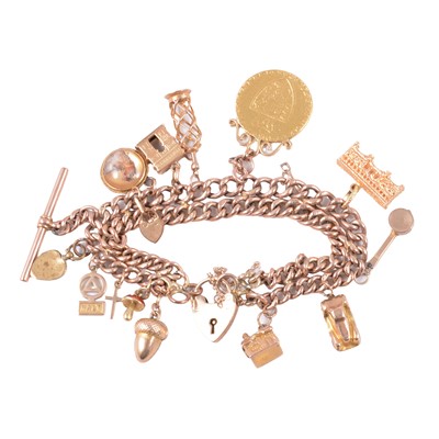 Lot 237 - A 9 carat rose gold charm bracelet with charms and 1788 Spade Guinea.