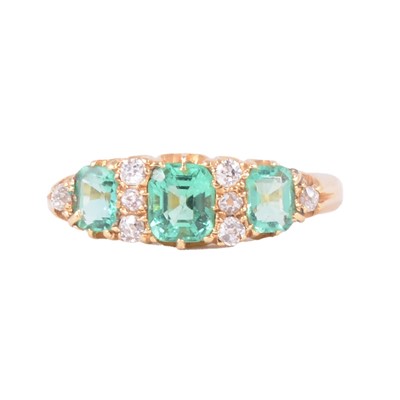 Lot 2 - An emerald and diamond half hoop ring.