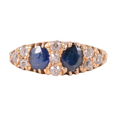 Lot 18 - A sapphire and diamond half hoop ring.