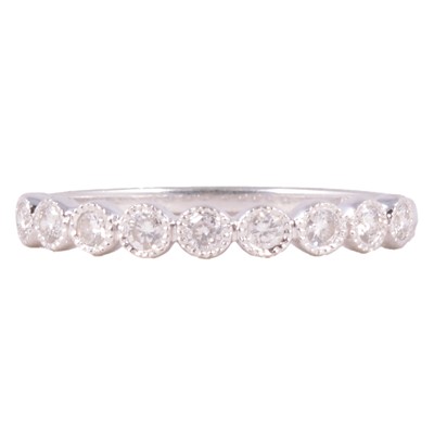 Lot 109 - A diamond half eternity ring.