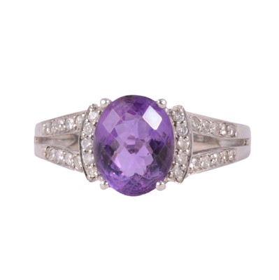 Lot 31 - An amethyst and diamond dress ring.