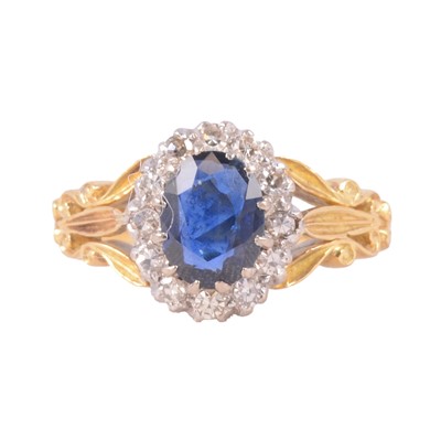 Lot 24 - A sapphire and diamond cluster ring.