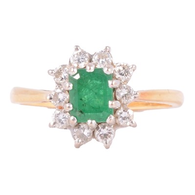 Lot 6 - An emerald and diamond cluster ring.