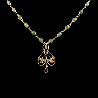 Lot 300 - A peridot, amethyst and seed pearl pendant on a turquoise and yellow metal necklace.