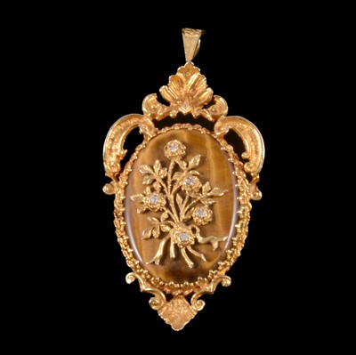 Lot 186 - A tiger's eye and diamond brooch pendant.