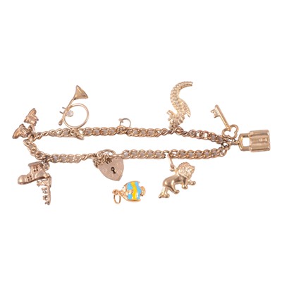 Lot 238 - A 9 carat gold charm bracelet with charms attached, and a loose charm.