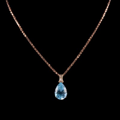 Lot 309 - A heat-treated blue topaz and diamond pendant on a chain, and a yellow metal bracelet.