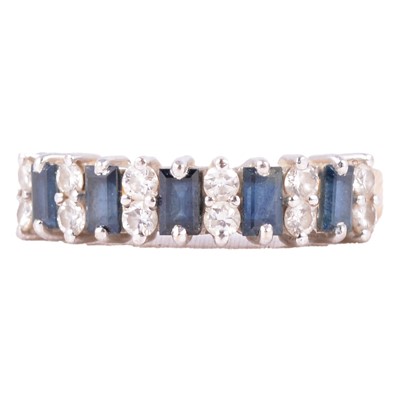 Lot 19 - A sapphire and diamond half eternity ring.