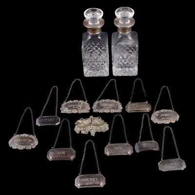 Lot 188 - Collection of eleven silver decanter labels, and pair of silver-collard decanters