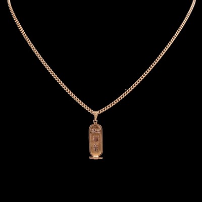 Lot 323 - A yellow metal Ancient Egyptian cartouche style pendant on a chain.