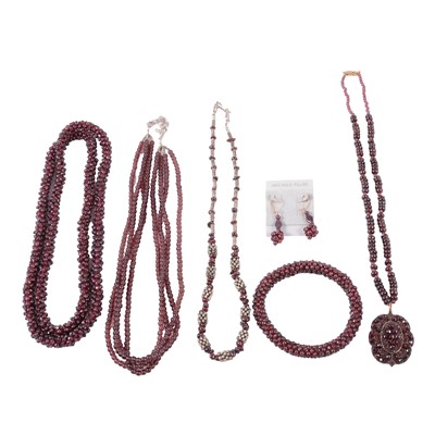 Lot 395 - A collection of garnet bead necklaces.