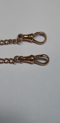 Lot 1099 - A 9 carat rose gold double Albert watch chain with fob.