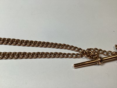 Lot 1099 - A 9 carat rose gold double Albert watch chain with fob.