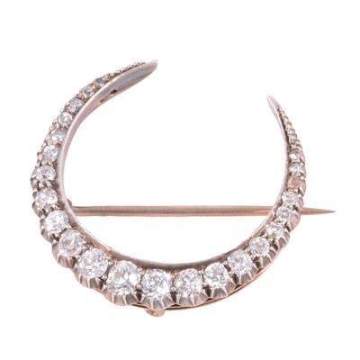 Lot 180A - A diamond closed crescent brooch.