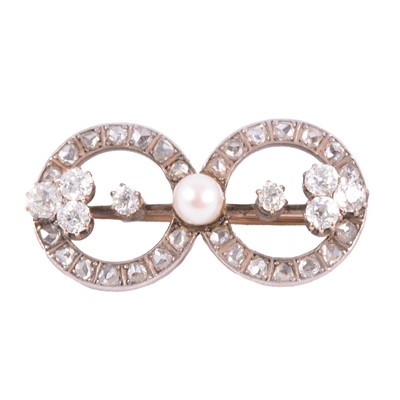 Lot 180B - A diamond and pearl double circle brooch.