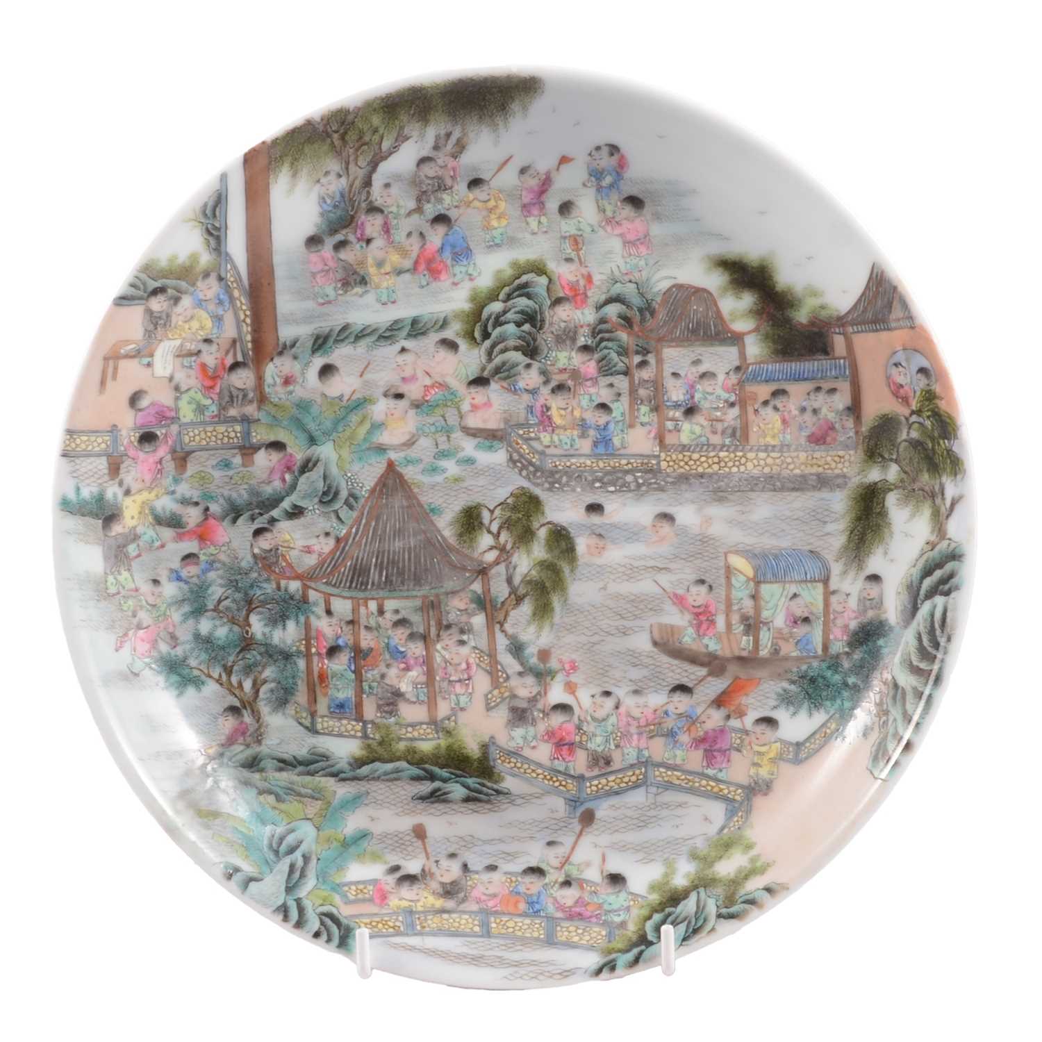 Lot 9 - Chinese porcelain polychrome dish with playful figures in a garden, Qing dynasty