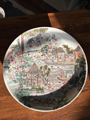 Lot 9 - Chinese porcelain polychrome dish with playful figures in a garden, Qing dynasty