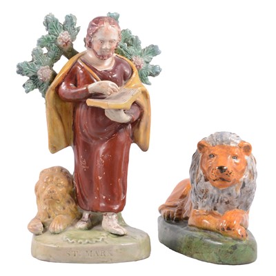 Lot 31 - Staffordshire figure of St Mark and a model of a recumbent lion