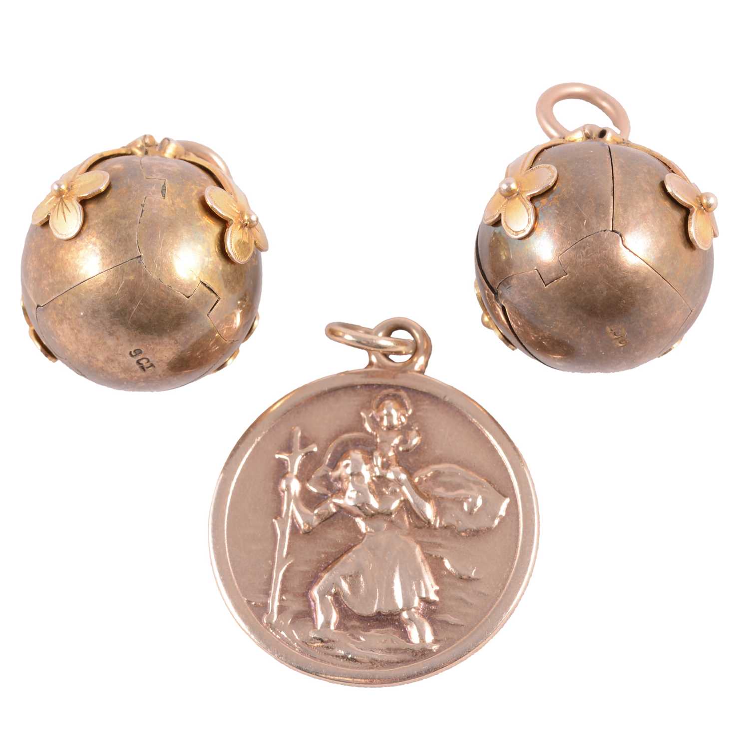 Lot 280 - Two transforming Masonic folding orb ball pendants, and a yellow metal St Christopher pendant.