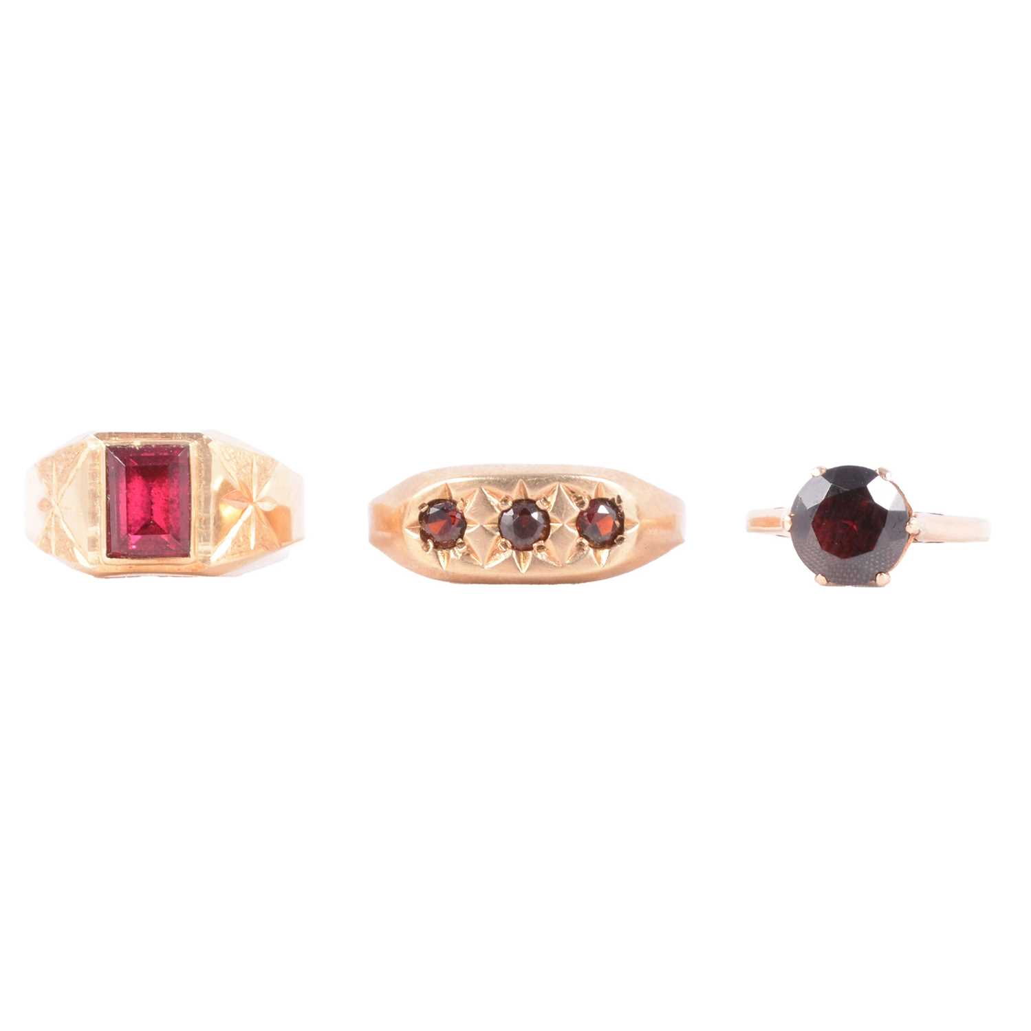 Lot 44 - Two garnet dress rings, and a synthetic pink stone dress ring.