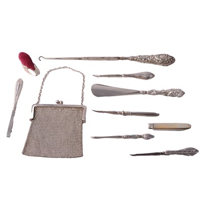 Lot 231 - Silver-handled buttonhook, shoe horn, manicure items, pin cushion, fruit knife, and chainmail purse.