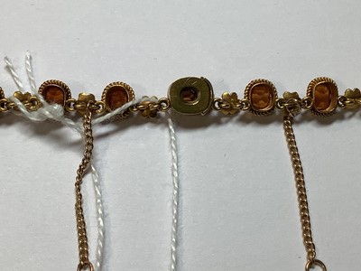 Lot 249 - A hessonite garnet and seed pearl graduated riviere necklace.