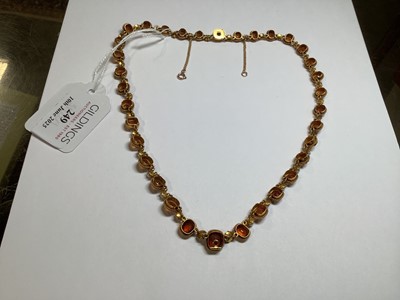 Lot 249 - A hessonite garnet and seed pearl graduated riviere necklace.