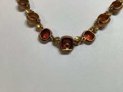 Lot 249 - A hessonite garnet and seed pearl graduated riviere necklace.