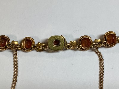 Lot 249 - A hessonite garnet and seed pearl graduated riviere necklace.