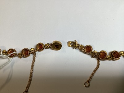 Lot 249 - A hessonite garnet and seed pearl graduated riviere necklace.