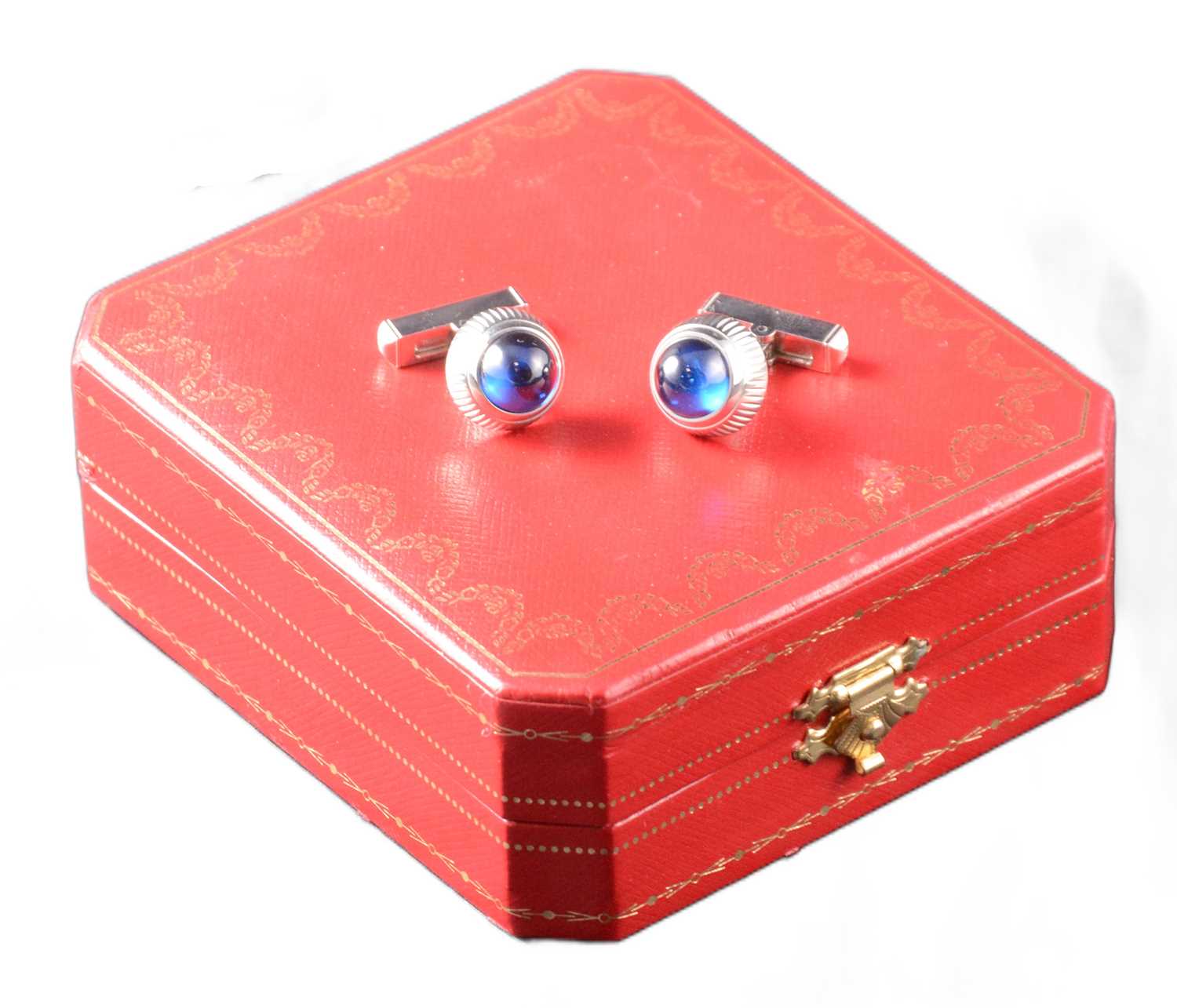 Lot 356 - Cartier - a pair of Santos Crown Decor silver cufflinks.