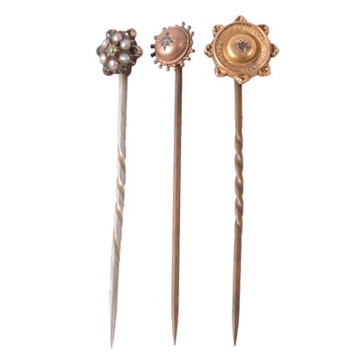 Lot 182 - Three gemset stick pins.